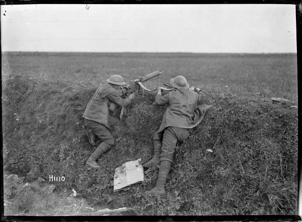 Two New Zealand soldiers firing a captured German machine gun at Beaudignies. 3 November 1918.